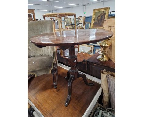 A 19th century yewwood tripod table.