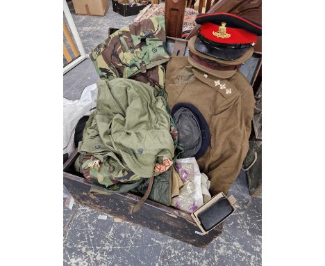 A uniform trunk containing 1953 battle dress and dress uniforms for the Royal artillery including caps, various webbing, a TA