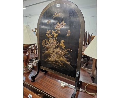 A chinoiserie gilt black lacquer round arch fire screen