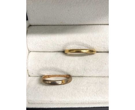 A 9ct hallmarked gold wedding ring and a 22ct gold example. 9ct weight 2.0 grams. 22ct weight 3.8 grams.