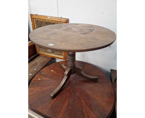 An oak tripod table together with an oak drop flap table