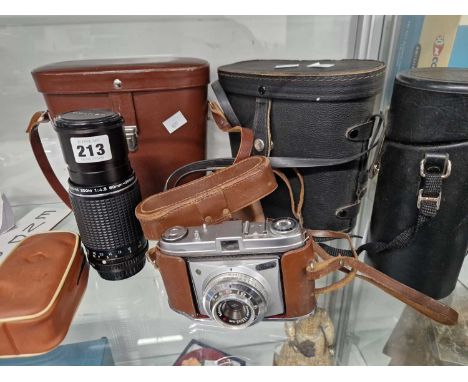 A Kodak Retinette camera, a Pentax zoom lens, two cased pairs of binoculars, etc.