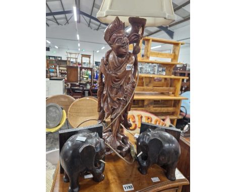 A Chinese hardwood figural table lamp together with a pair of Indian elephant form bookends