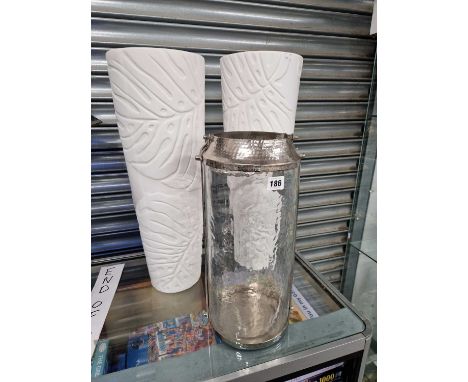 A pair of leaf moulded white vases together with a chrome mounted cylindrical candle lantern