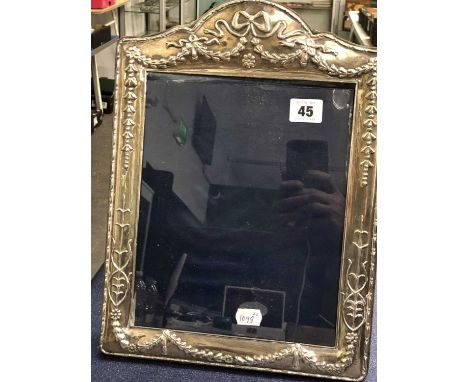 A large hallmarked silver easel back photo frame. 