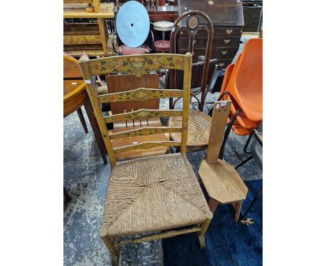 A rush seated painted ladder back chair, two other chairs together with a bentwood chair