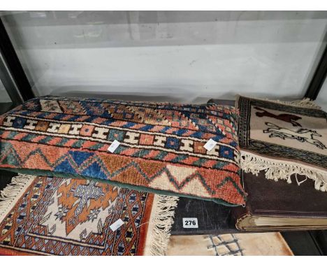 A large leather-bound monogrammed scrapbook, (empty) two small woven carpet squares and a woven carpet cushion. 