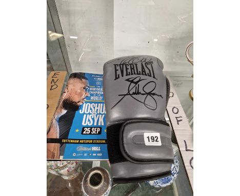 A 2021 world boxing championship programme together with a signed boxing glove