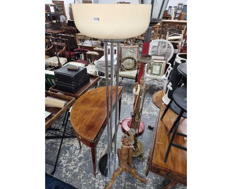 A chrome standard lamp with a glass uplighter shade, a wooden tripod standard lamp and another in adjustable brass