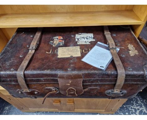 A large leather cabin trunk.