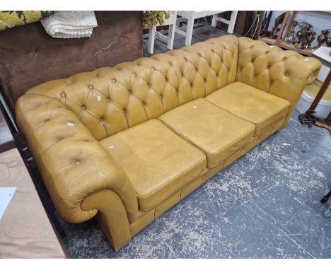 A vintage leather button upholstered chesterfield sofa.