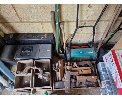 A large collection of garden and woodworking tools.