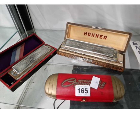 Three case Hohner harmonicas