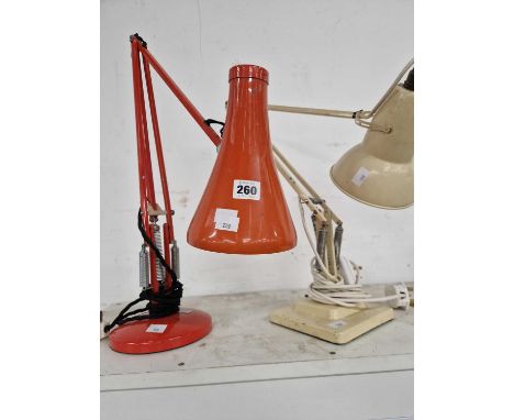 A red and a cream angle poise lamp