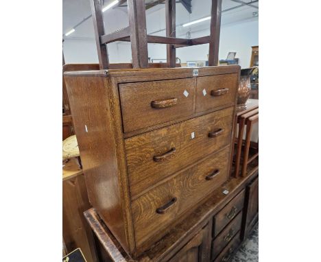 A 1940's oak chest of two short and two long drawers together with a nest of three tile topped mahogany tables