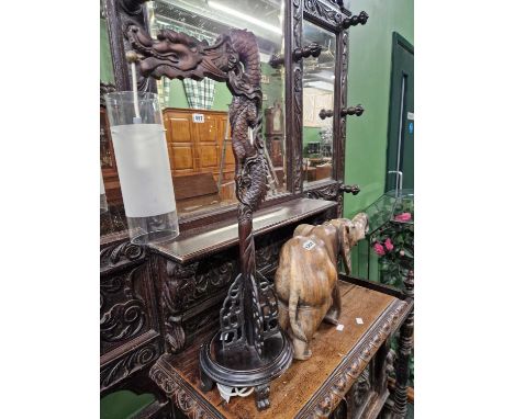 A dragon form lantern and a carved hardwood elephant. 