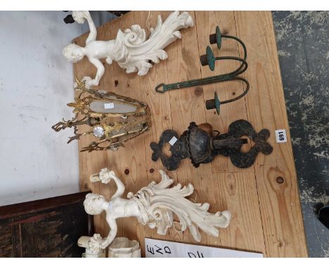 A pair of cherubs form wall lights, two other wall lights and a gilded ceiling light