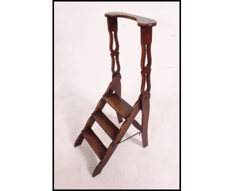 A Victorian mahogany 3 step library scissor ladder. The metamorphic folding action with 3 steps and top plate with lattice si