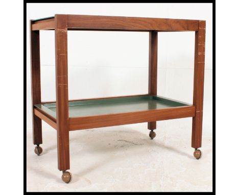 A vintage Danish influence / possibly Air Ministry teak and plastic butlers serving trolley. The twin green trays inset to a 