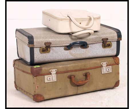 A stack of vintage suitcases and a ladies vanity case together with 2 lambs wool retro style rugs. Largest measures H60 x W20