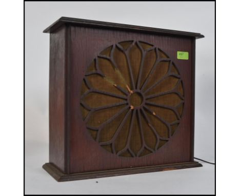 A vintage wooden early 20th century radio having speaker front, the reverse with dial knob marked bluespot