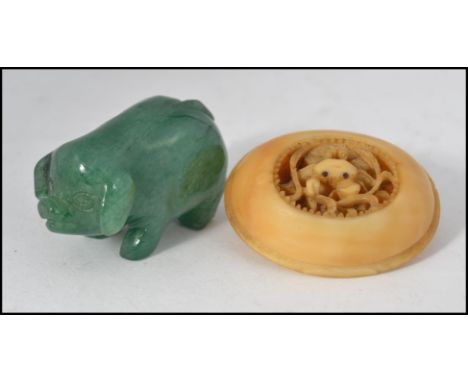 A small 20th century Jade carving of a pig, approx 4cm in length, along with a beautifully carved and pierced ivory/bone/resi