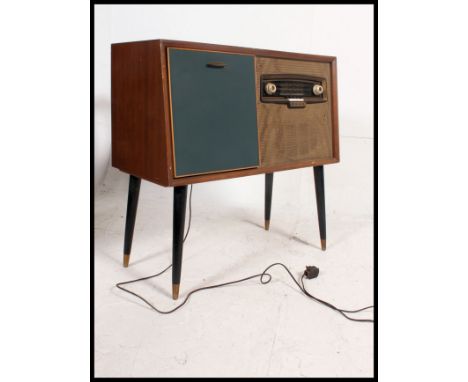 A vintage mid 20th century Bush radiogram having an inset RC121 Garrard deck. The cabinet in teak and vinyl raised on taperin