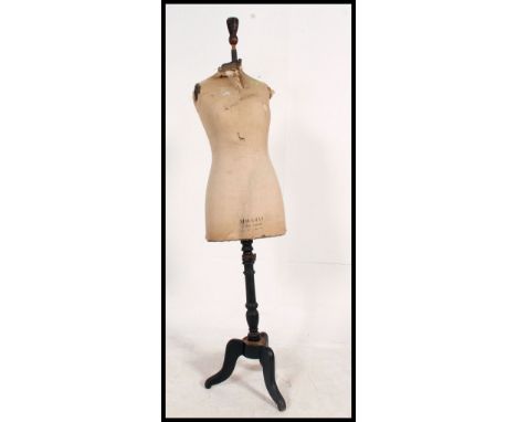 An early 20th century Stockman of Paris & London tailors haberdashery dummy - mannequin being raised on tripod base with 3/4 