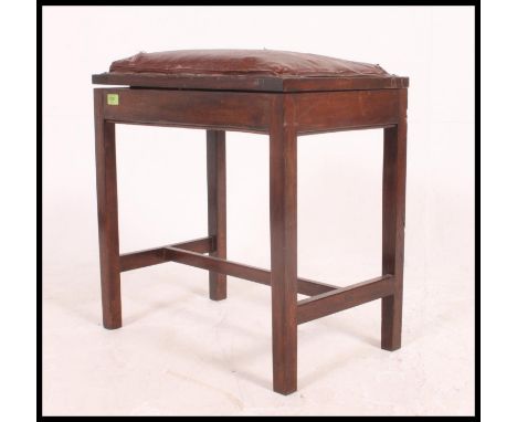 A Victorian oak duet / piano stool raised on tapered square legs with upholstered seat with hinged top and sheet music storag
