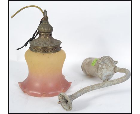 A vintage 20th century Industrial dairy lamp on shaped arm with glass shade together with a coloured arts & crafts lantern sh