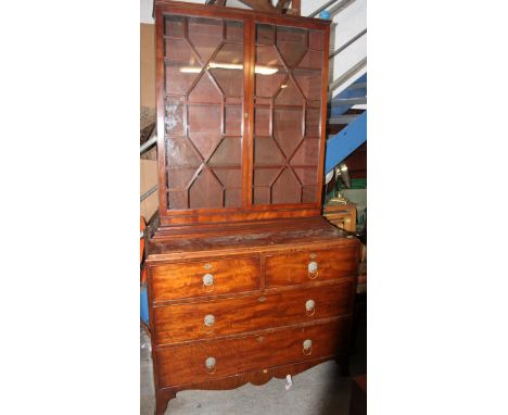 A 19th century Georgian mahogany bookcase on chest of drawers. The chest raised on squared bracket feet with short and deep d