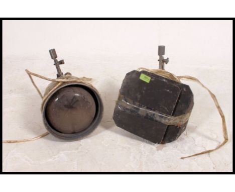 A pair of vintage 20th century theatre spot lights, one retaining barn doors, both with the original cast brackets