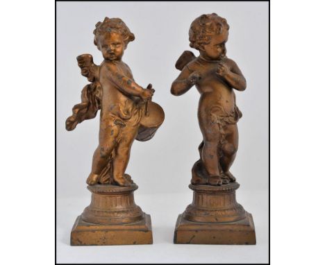 2 Victorian gilded spelter figurines of cherub - putti playing musical instruments - each raised on socle plinths H18cm