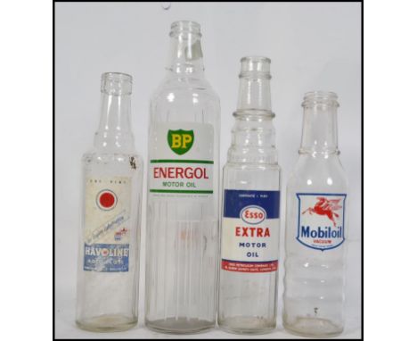 A collection of vintage mid century Industrial advertising automobilia glass oil bottles to include BP, Mobil, Havoline and E