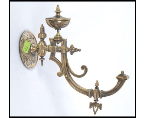 A Victorian / Edwardian early 20th century wall mountable metal spirit lamp bracket of unusual form.