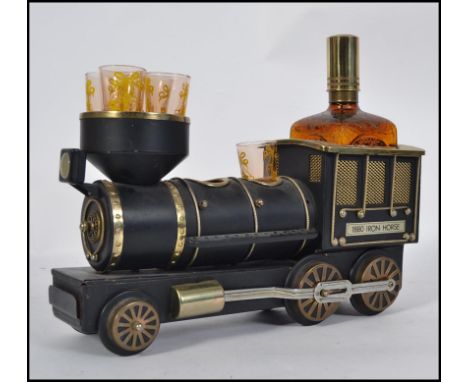 A retro vintage 1970's drinks / liqueur set in the form of a train being musical having decanter and shot glasses L34cm