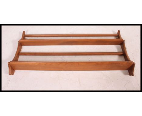 A 20th century Golden Dawn two tier Ercol plate rack with applied blue Ercol sticker to the rear. H50cm