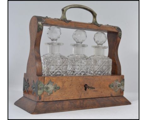 A stunning Victorian miniature walnut and cut glass 3 piece tantalus / decanter set. Complete with key, the walnut stand embe