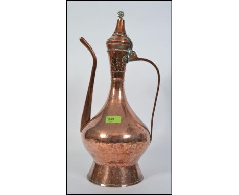 A tall early 20th century middle eastern copper metalware coffee pot, probably Turkish, hand beaten body tapering circular fo