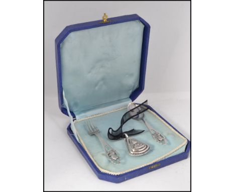 A silver continental cased Christening set consisting of a babies rattle on lace with  spoon and fork with marks for Porto. C