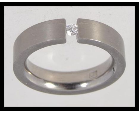 A titanium contemporary band ring with inset diamond single stone approx 5pnts. Weight 4.1g / Size O