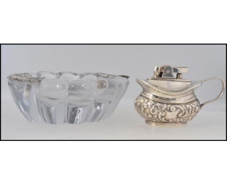 A silver white metal adorned cut glass ashtray together with an automatic table lighter - Musda Period Series  silver plate H