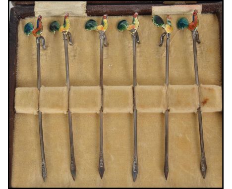 A cased set of six silver hallmarked enamelled cocktail sticks depicting cockerel's in the original presentation case with a 