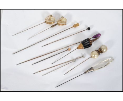 A collection of Victorian hatpins to include gold top ball finial pin along with others