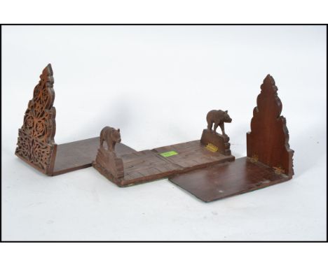 A pair of mid century Black Forest carved book trough / bookends in the form of Boars along with another pair of bookends L31