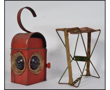 A vintage Kenyon's Industrial  roadside industrial work lamp, along with a similar age folding workman's stool Lamp H46cm