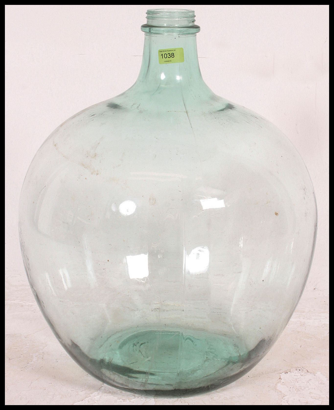 A vintage 20th century large bulbous glass acid carboy bottle with thin