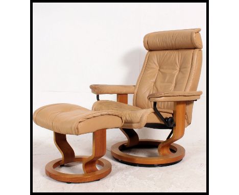 A vintage 20th century Ekornes ' Stressless ' reclining swivel armchair raised on bentwood base with tan leather upholstery c