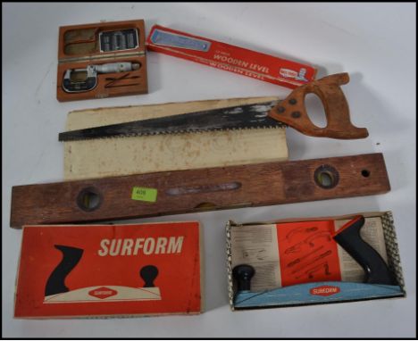 A collection of vintage tools to include spirit measure, saws, planes and other woodworking tools etc