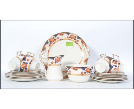 An Art Deco tea service by Hughes and Co Langton, in a floral chintz pattern consisting of six trio's, creamer, sugar bowl an